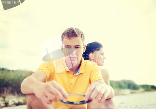 Image of stressed couple outside