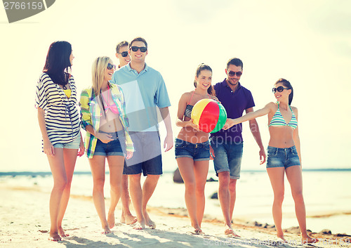 Image of group of friends having fun on the beach