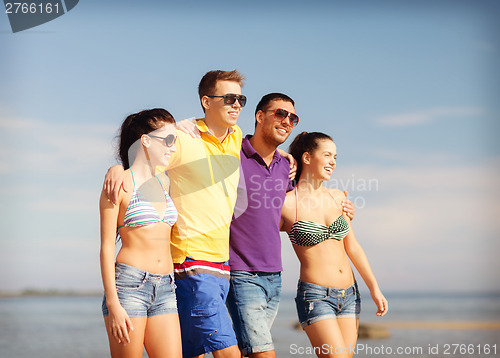 Image of group of friends having fun on the beach