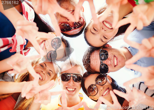Image of group of teenagers showing finger five gesture
