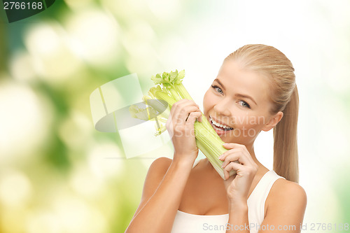 Image of woman biting piece of celery or green salad