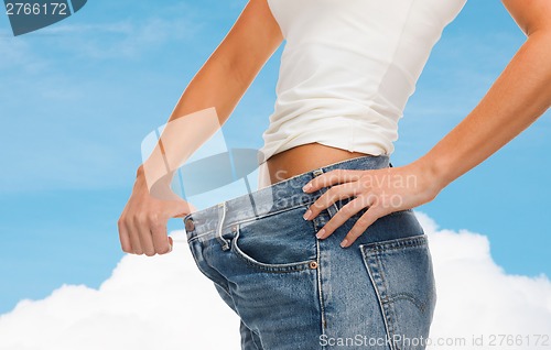 Image of close up of female showing big jeans