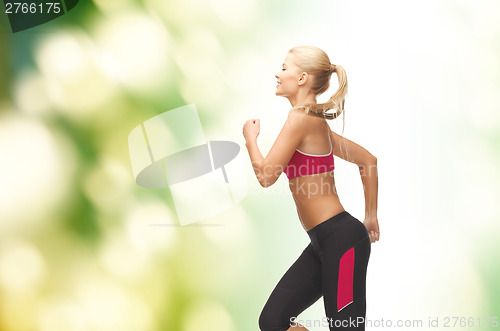 Image of sporty woman running or jumping