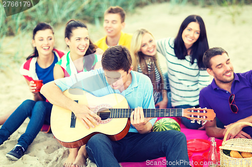 Image of group of friends having fun on the beach