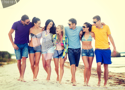 Image of group of friends having fun on the beach