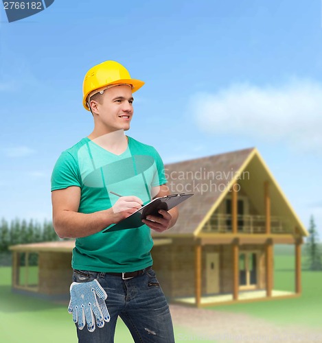 Image of smiling man in helmet with clipboard