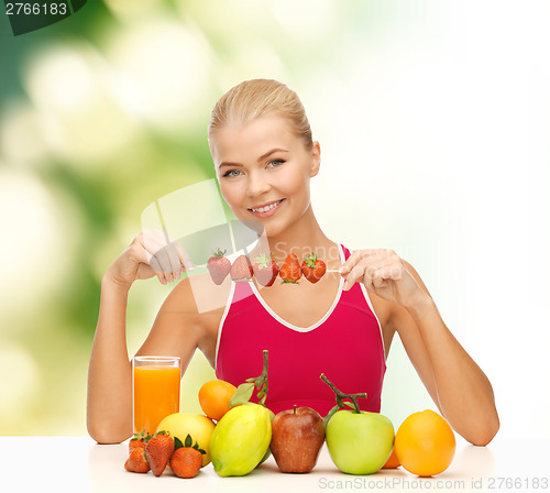 Image of smiling young woman with organic food on the table