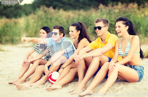 Image of group of friends having fun on the beach