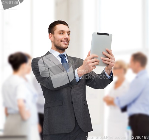 Image of smiling buisnessman with tablet pc computer