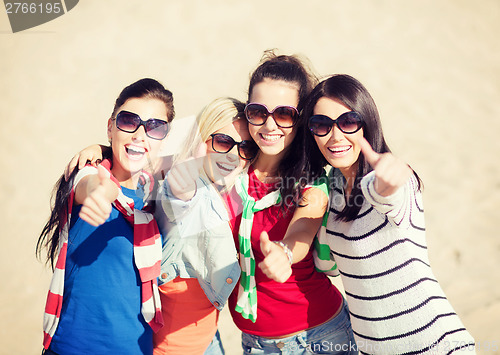 Image of teenage girls or young women showing thumbs up