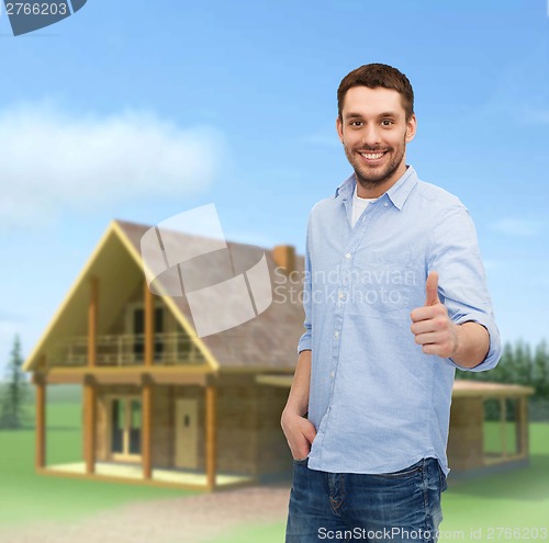 Image of smiling man showing thumbs up