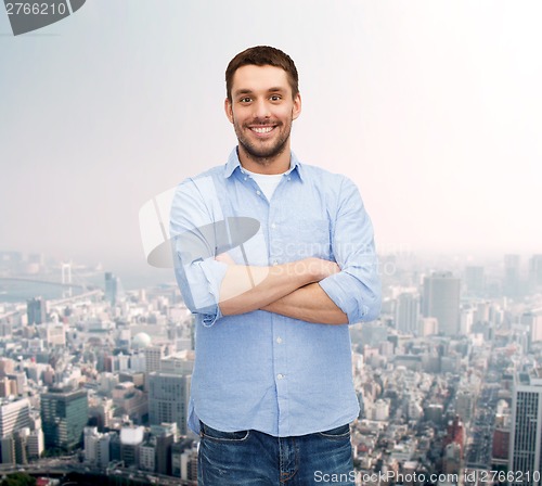 Image of smiling man with crossed arms