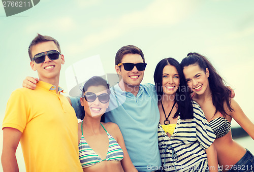 Image of group of friends having fun on the beach