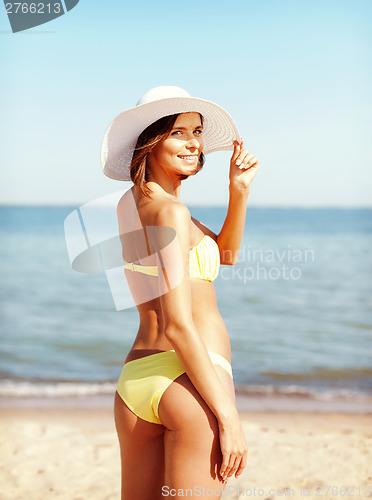 Image of girl in bikini standing on the beach