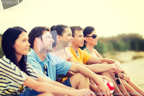 Image of group of friends having fun on the beach