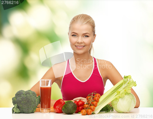 Image of smiling young woman with organic food on the table