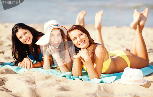 Image of girls sunbathing on the beach