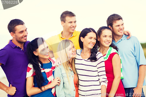 Image of group of friends having fun on the beach
