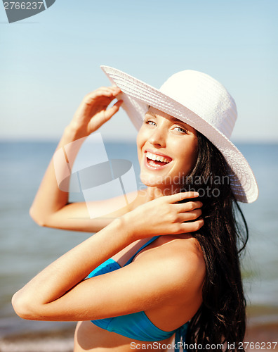 Image of girl in bikini standing on the beach