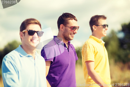 Image of group of friends walking on the beach