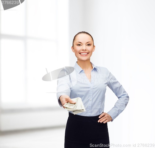 Image of young businesswoman with dollar cash money