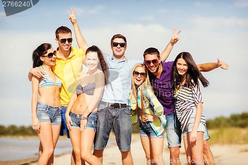 Image of group of friends having fun on the beach