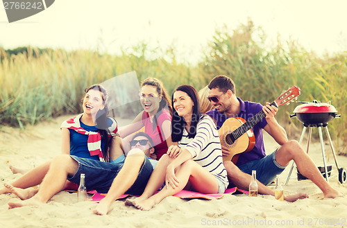 Image of group of friends having fun on the beach