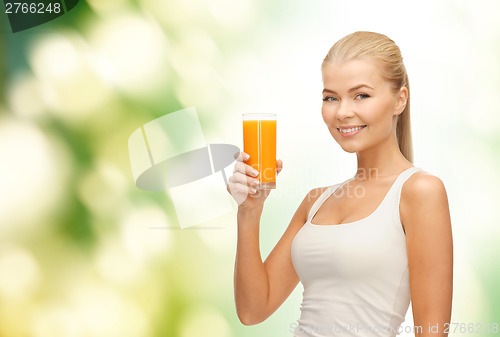 Image of smiling woman holding glass of orange juice