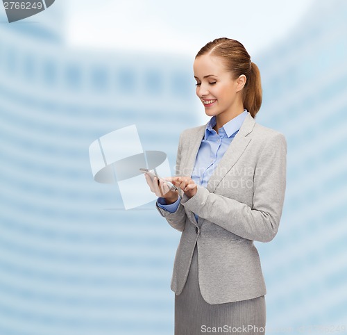 Image of young smiling businesswoman with smartphone