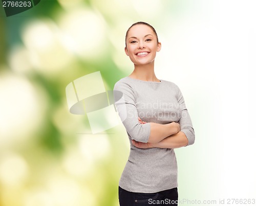Image of smiling asian woman over with crossed arms