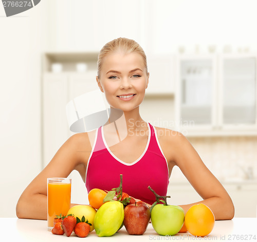 Image of smiling woman with organic food or fruits on table