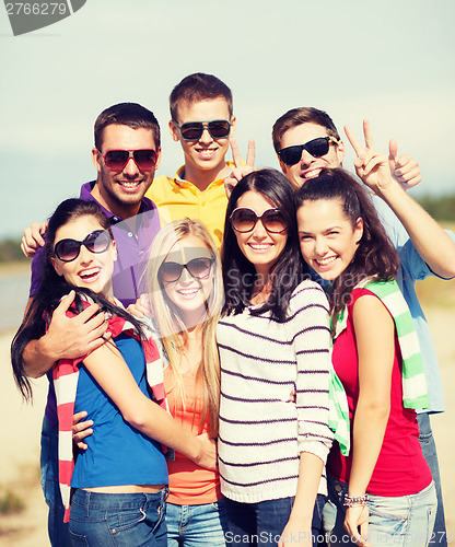 Image of group of friends having fun on the beach