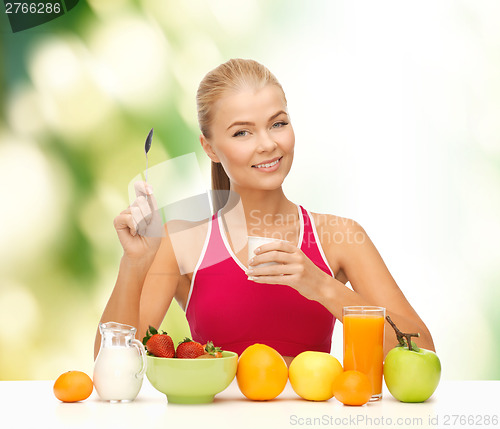 Image of young woman eating healthy breakfast