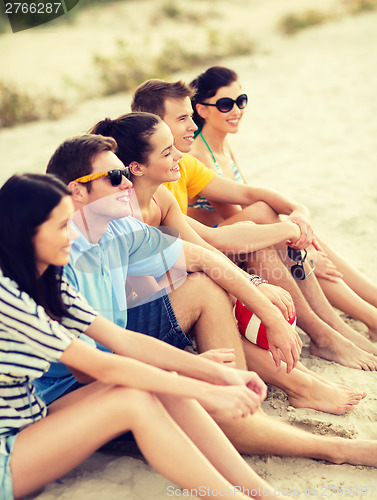 Image of group of friends having fun on the beach