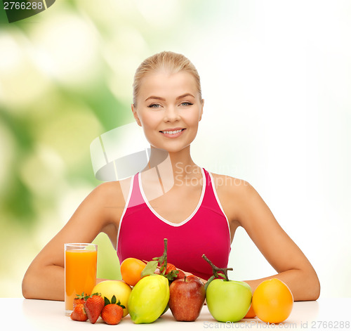 Image of smiling woman with organic food or fruits on table