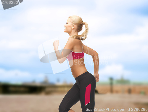 Image of sporty woman running or jumping