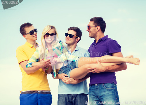 Image of group of friends having fun on the beach