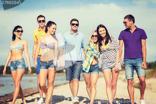 Image of group of friends having fun on the beach