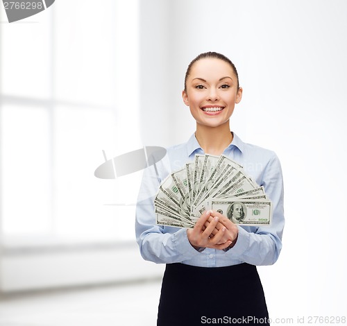 Image of young businesswoman with dollar cash money