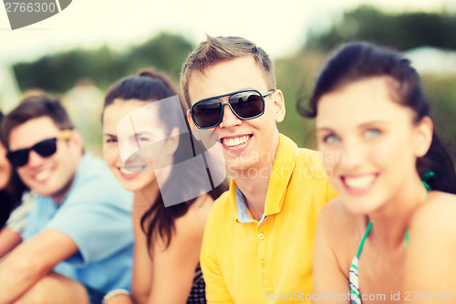 Image of group of friends having fun on the beach