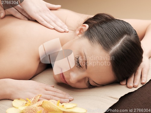 Image of beautiful woman in massage salon