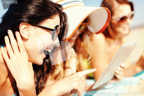 Image of girls with tablet pc on the beach