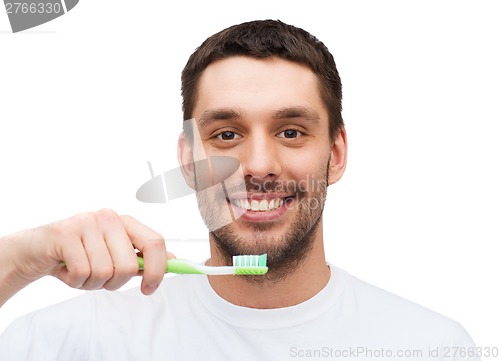 Image of smiling young man with toothbrush