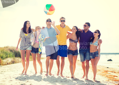 Image of group of friends having fun on the beach