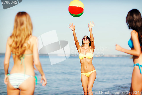 Image of girls with ball on the beach
