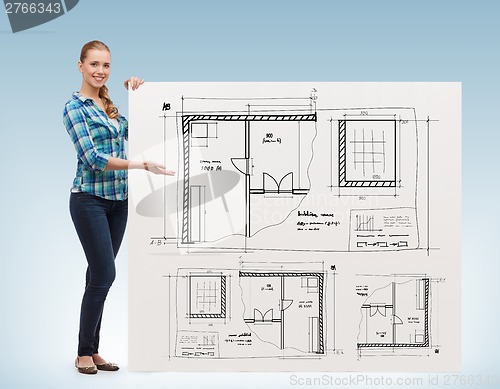 Image of smiling young woman with white board and blueprint