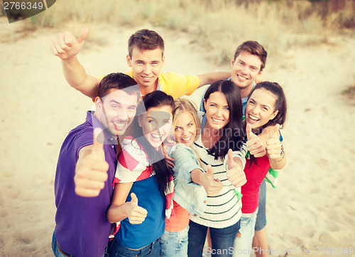 Image of group of friends having fun on the beach