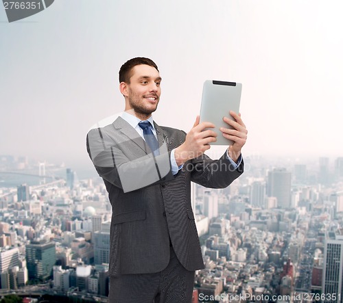 Image of smiling buisnessman with tablet pc computer