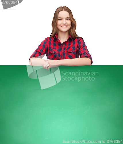 Image of smiling young teenage girl with white blank board