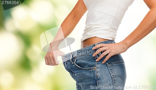 Image of close up of female showing big jeans